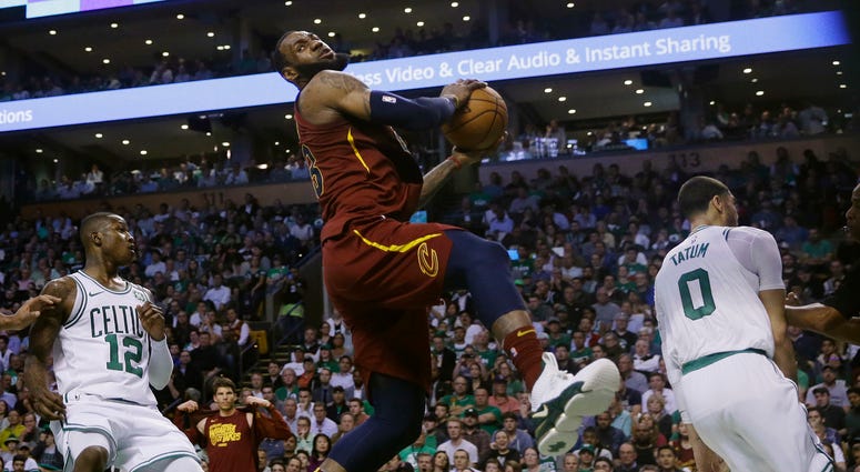 Cavaliers forward LeBron James, center, recoils after colliding with Boston Celtics forward Jayson Tatum, right, in front of Celtics guard Terry Rozier, left, during the first half in Game 2 of the NBA basketball Eastern Conference finals Cavaliers forward LeBron James, center, recoils after colliding with Boston Celtics forward Jayson Tatum, right, in front of Celtics guard Terry Rozier, left, during the first half in Game 2 of the NBA basketball Eastern Conference finals