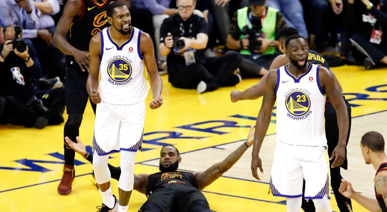 Cleveland Cavaliers forward LeBron James (23) reacts between guard Jordan Clarkson (8) and Golden State Warriors forward Kevin Durant during the second half of Game 1 of basketball's NBA Finals in Oakland, Calif., Thursday, May 31, 2018. Cleveland Cavaliers forward LeBron James (23) reacts between guard Jordan Clarkson (8) and Golden State Warriors forward Kevin Durant during the second half of Game 1 of basketball's NBA Finals in Oakland, Calif., Thursday, May 31, 2018.