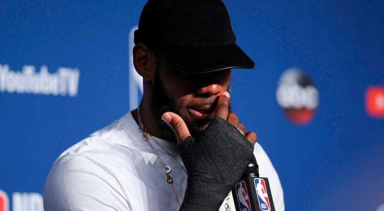 Cleveland Cavaliers forward LeBron James wipes his face during a news conference following Game 4 of basketball's NBA Finals against the Golden State Warriors, early Saturday, June 9, 2018, in Cleveland Cleveland Cavaliers forward LeBron James wipes his face during a news conference following Game 4 of basketball's NBA Finals against the Golden State Warriors, early Saturday, June 9, 2018, in Cleveland