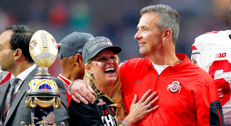 Ohio State head coach Urban Meyer hugs his wife, Shelley, after their 44-28 win over Notre Dame in the Fiesta Bowl NCAA college football game, in Glendale, Ariz. Ohio State placed Meyer on paid administrative leave Wednesday, Aug. 1, 2018, while it invest Ohio State head coach Urban Meyer hugs his wife, Shelley, after their 44-28 win over Notre Dame in the Fiesta Bowl NCAA college football game, in Glendale, Ariz. Ohio State placed Meyer on paid administrative leave Wednesday, Aug. 1, 2018, while it invest
