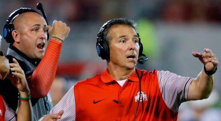 FILE - In this Sept. 17, 2016, file photo, Ohio State head coach Urban Meyer, right, and then-assistant coach Zach Smith, left, gesture from the sidelines during an NCAA college football game against Oklahoma in Norman, Okla. FILE - In this Sept. 17, 2016, file photo, Ohio State head coach Urban Meyer, right, and then-assistant coach Zach Smith, left, gesture from the sidelines during an NCAA college football game against Oklahoma in Norman, Okla.