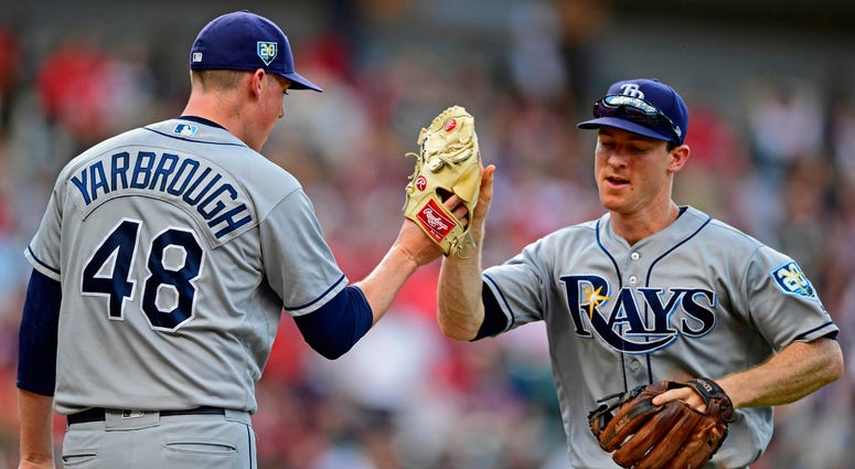 Tampa Bay Rays' Joey Wendle, right, is congratulated by relief pitcher Ryan Yarbrough after throwing out Cleveland Indians' Francisco Lindor in the third inning of a baseball game, Sunday, Sept. 2, 2018, in Cleveland. Tampa Bay Rays' Joey Wendle, right, is congratulated by relief pitcher Ryan Yarbrough after throwing out Cleveland Indians' Francisco Lindor in the third inning of a baseball game, Sunday, Sept. 2, 2018, in Cleveland.