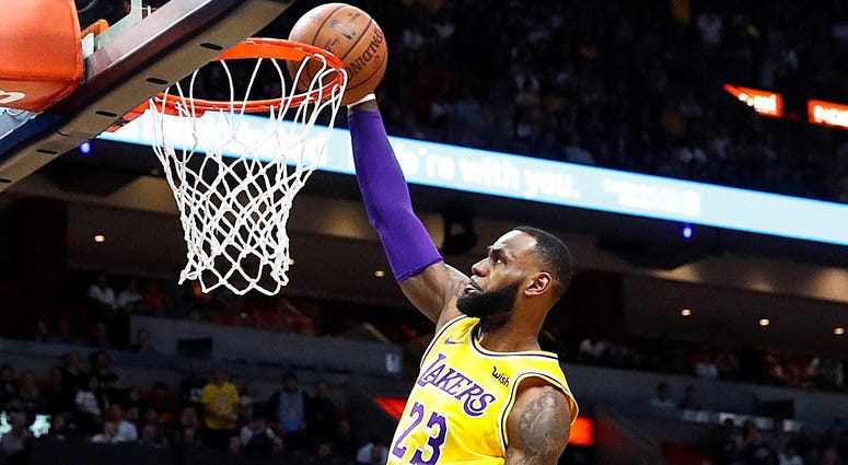 Los Angeles Lakers forward LeBron James scores during the first quarter of an NBA basketball game against the Miami Heat, Sunday, Nov. 18, 2018, in Miami, Fla.