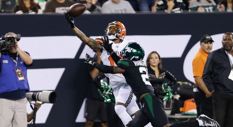 Cleveland Browns' Odell Beckham (13) catches a pass in front of New York Jets' Nate Hairston (21) during the first half of an NFL football game Monday, Sept. 16, 2019, in East Rutherford, N.J.