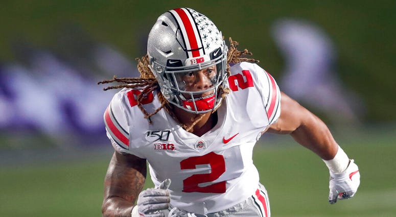 FILE - In this Oct. 18, 2019, file photo, Ohio State defensive end Chase Young rushes against Northwestern during the second half of an NCAA college football game, in Evanston, Ill. Ohio State says defensive end Chase Young won't play Saturday against Mar FILE - In this Oct. 18, 2019, file photo, Ohio State defensive end Chase Young rushes against Northwestern during the second half of an NCAA college football game, in Evanston, Ill. Ohio State says defensive end Chase Young won't play Saturday against Mar