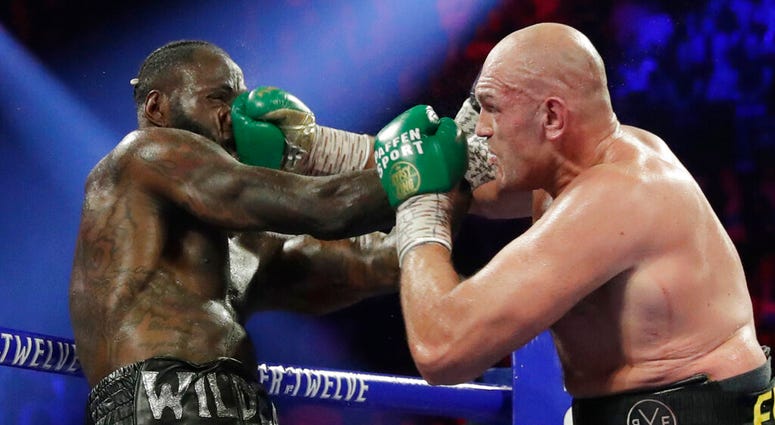 Tyson Fury, of England, lands a right to Deontay Wilder during a WBC heavyweight championship boxing match Saturday, Feb. 22, 2020, in Las Vegas. (AP Photo/Isaac Brekken)