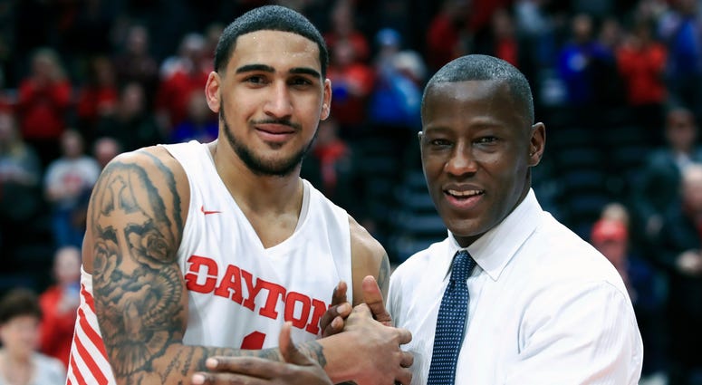 FILE - In this Feb. 22, 2020, file photo, Dayton's Obi Toppin, left, celebrates scoring his 1,000th career point with head coach Anthony Grant after an NCAA college basketball game against Duquesne, in Dayton, Ohio. Toppin and Grant have claimed top honor