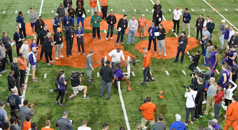 FILE - In this March 12, 2020, file photo, Clemson football player Tee Higgins lifts weights during NFL Pro Day in Clemson, S.C. Scouts, front-office executives and even coaches find themselves coping with a whole new process with Americans hunkering down