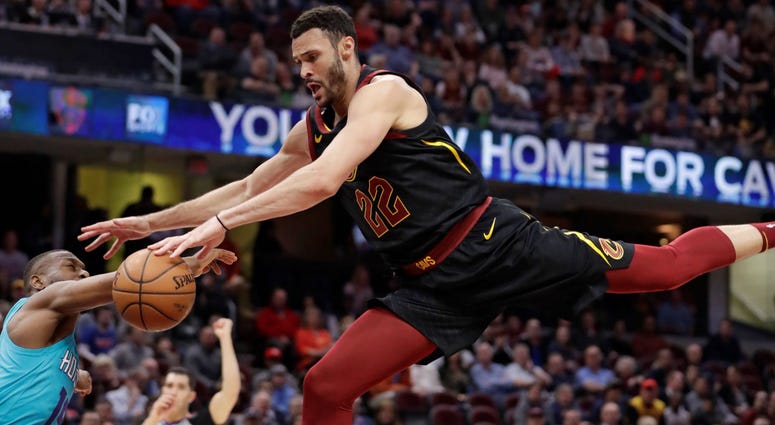 Cleveland Cavaliers' Larry Nance Jr., right, drives to the basket against Charlotte Hornets' Kemba Walker in the first half of an NBA basketball game, Tuesday, April 9, 2019, in Cleveland. Walker was called for a foul.