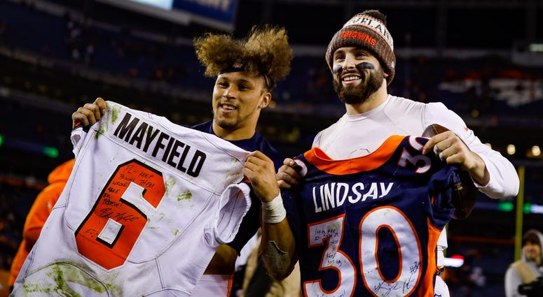 DENVER, CO - DECEMBER 15: Running back Phillip Lindsay #30 of the Denver Broncos and quarterback Baker Mayfield #6 of the Cleveland Browns stand with exchanged jerseys after a game at Broncos Stadium at Mile High on December 15, 2018 in Denver, Colorado. DENVER, CO - DECEMBER 15: Running back Phillip Lindsay #30 of the Denver Broncos and quarterback Baker Mayfield #6 of the Cleveland Browns stand with exchanged jerseys after a game at Broncos Stadium at Mile High on December 15, 2018 in Denver, Colorado.