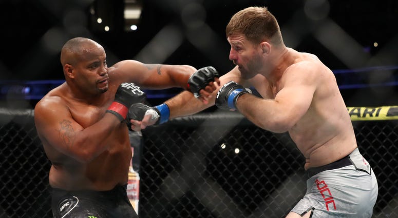 ANAHEIM, CALIFORNIA - AUGUST 17: Daniel Cormier throws a punch at Stipe Miocic in the first round during their UFC Heavyweight Title Bout at UFC 241 at Honda Center on August 17, 2019 in Anaheim, California. Daniel Cormier throws a punch at Stipe Miocic in the first round during their UFC Heavyweight Title Bout at UFC 241 at Honda Center on August 17, 2019 in Anaheim, California.