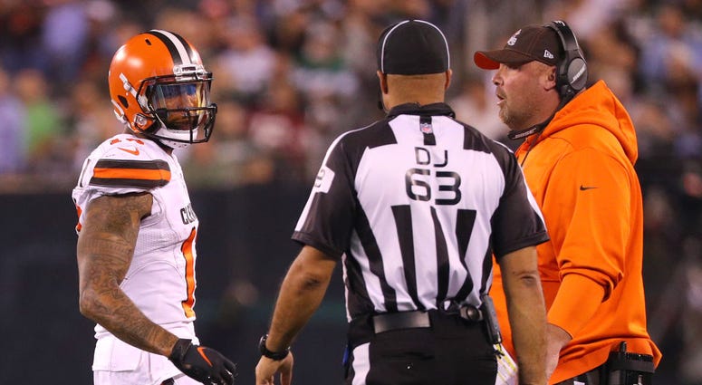 Odell Beckham #13 of the Cleveland Browns speaks to back judge Jim Quirk #63 as he's told to leave the field for a play in the first quarter as head coach Freddie Kitchens looks on at MetLife Stadium on September 16, 2019