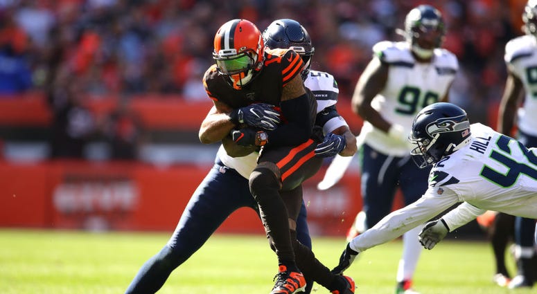 CLEVELAND, OHIO - OCTOBER 13: Odell Beckham #13 of the Cleveland Browns is tackled by K.J. Wright #50 of the Seattle Seahawks and Lano Hill #42 after a third quarter catch at FirstEnergy Stadium on October 13, 2019 in Cleveland, Ohio. (Photo by Gregory Sh CLEVELAND, OHIO - OCTOBER 13: Odell Beckham #13 of the Cleveland Browns is tackled by K.J. Wright #50 of the Seattle Seahawks and Lano Hill #42 after a third quarter catch at FirstEnergy Stadium on October 13, 2019 in Cleveland, Ohio. (Photo by Gregory Sh