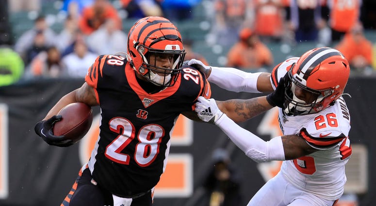 Joe Mixon #28 of the Cincinnati Bengals runs with the ball while defended by Greedy Williams #26 of the Cleveland Browns at Paul Brown Stadium on December 29, 2019 in Cincinnati, Ohio. (Photo by Andy Lyons/Getty Images) Joe Mixon #28 of the Cincinnati Bengals runs with the ball while defended by Greedy Williams #26 of the Cleveland Browns at Paul Brown Stadium on December 29, 2019 in Cincinnati, Ohio. (Photo by Andy Lyons/Getty Images)