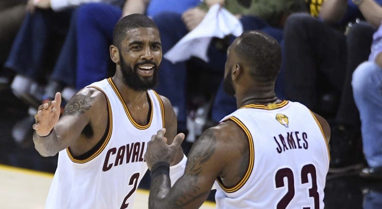 Cleveland Cavaliers guard Kyrie Irving (2) celebrates with forward LeBron James (23) during the third quarter against the Golden State Warriors in game three of the 2017 NBA Finals at Quicken Loans Arena.