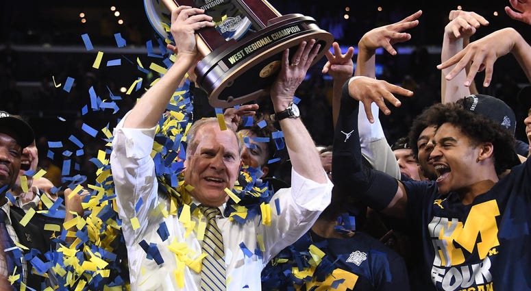 Mar 24, 2018; Los Angeles, CA, USA; Michigan Wolverines head coach John Beilein celebrates with the trophy after the Michigan Wolverines defeated the Florida State Seminoles in the championship game of the West regional of the 2018 NCAA Tournament at STAP Mar 24, 2018; Los Angeles, CA, USA; Michigan Wolverines head coach John Beilein celebrates with the trophy after the Michigan Wolverines defeated the Florida State Seminoles in the championship game of the West regional of the 2018 NCAA Tournament at STAP