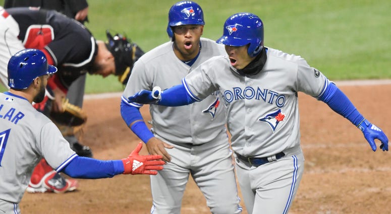 Apr 13, 2018; Cleveland, OH, USA; Toronto Blue Jays shortstop Aledmys Diaz (right) celebrates with third baseman Yangervis Solarte (26) and center fielder Kevin Pillar (11) after hitting a three-run home run in the fourth inning. Apr 13, 2018; Cleveland, OH, USA; Toronto Blue Jays shortstop Aledmys Diaz (right) celebrates with third baseman Yangervis Solarte (26) and center fielder Kevin Pillar (11) after hitting a three-run home run in the fourth inning.