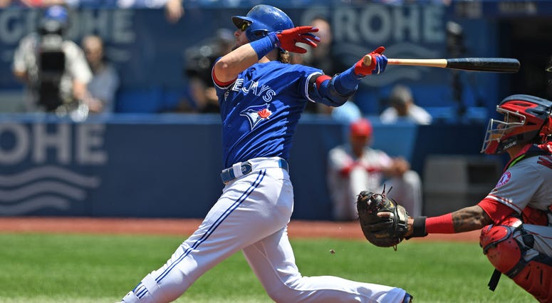 May 24, 2018; Toronto, Ontario, CAN; Toronto Blue Jays third base Josh Donaldson (20) hits a single during the regular season MLB game between the Los Angeles Angels and Toronto Blue Jays at Rogers Centre. May 24, 2018; Toronto, Ontario, CAN; Toronto Blue Jays third base Josh Donaldson (20) hits a single during the regular season MLB game between the Los Angeles Angels and Toronto Blue Jays at Rogers Centre.