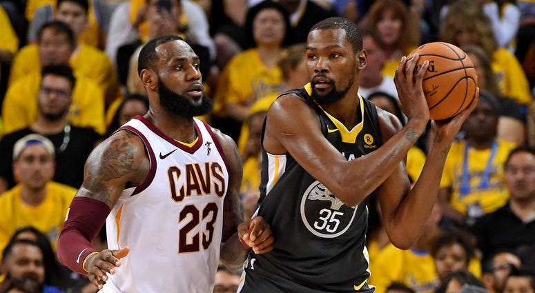 Golden State Warriors forward Kevin Durant (35) handles the ball against Cleveland Cavaliers forward LeBron James (23) during the second quarter in game two of the 2018 NBA Finals Golden State Warriors forward Kevin Durant (35) handles the ball against Cleveland Cavaliers forward LeBron James (23) during the second quarter in game two of the 2018 NBA Finals