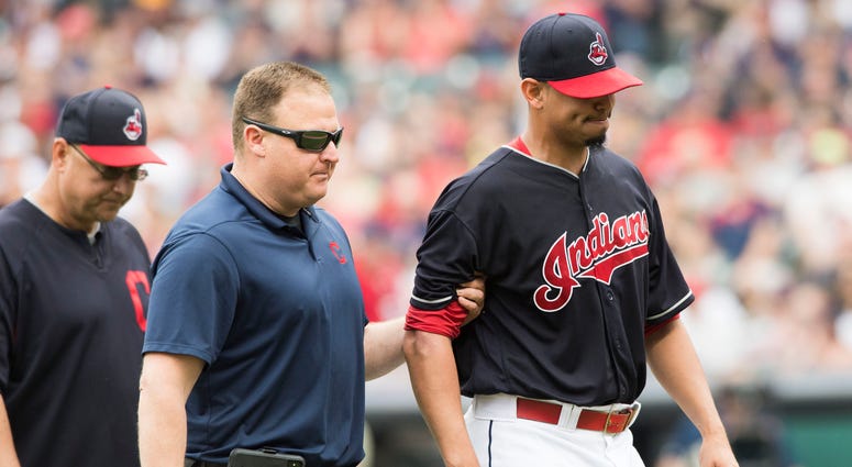 Jun 16, 2018; Cleveland, OH, USA; Cleveland Indians starting pitcher Carlos Carrasco (59) is led off the field after being injured during the second inning against the Minnesota Twins at Progressive Field. Jun 16, 2018; Cleveland, OH, USA; Cleveland Indians starting pitcher Carlos Carrasco (59) is led off the field after being injured during the second inning against the Minnesota Twins at Progressive Field.