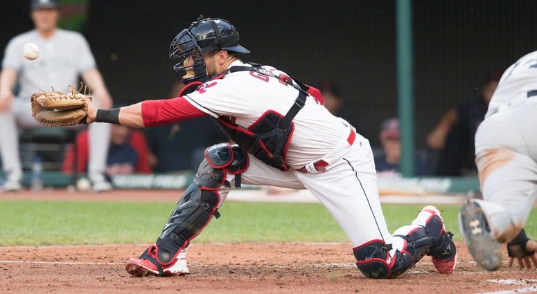 Jul 13, 2018; Cleveland, OH, USA; Cleveland Indians catcher Yan Gomes (7) misplays the ball on a sacrifice hit by New York Yankees left fielder Brett Gardner as New York Yankees second baseman Neil Walker (14) sores during the fifth inning at Progressive Jul 13, 2018; Cleveland, OH, USA; Cleveland Indians catcher Yan Gomes (7) misplays the ball on a sacrifice hit by New York Yankees left fielder Brett Gardner as New York Yankees second baseman Neil Walker (14) sores during the fifth inning at Progressive