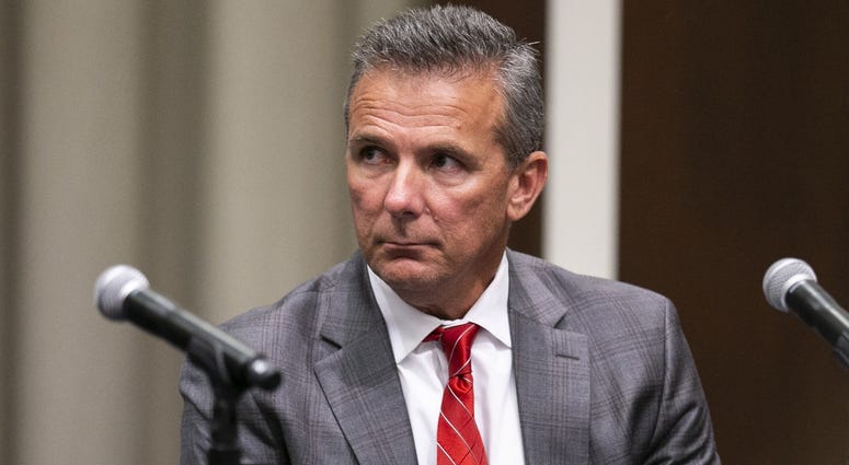 Ohio State Buckeyes head coach Urban Meyer listens as university president Michael Drake at Longaberger Alumni House speaks on the Ohio State University campus. Ohio State Buckeyes head coach Urban Meyer listens as university president Michael Drake at Longaberger Alumni House speaks on the Ohio State University campus.