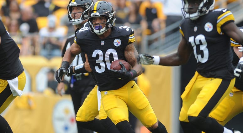 Pittsburgh Steelers running back James Conner (30) picks up short yards in the first quarter against the Tennessee Titans at Heinz Field Pittsburgh Steelers running back James Conner (30) picks up short yards in the first quarter against the Tennessee Titans at Heinz Field