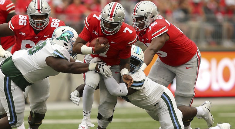 Ohio State Buckeyes quarterback Dwayne Haskins (7) tackled by Tulane Green Wave nose tackle De'Andre Williams (left) and defensive end Juan Monjarres (44) during the first quarter at Ohio Stadium. Ohio State Buckeyes quarterback Dwayne Haskins (7) tackled by Tulane Green Wave nose tackle De'Andre Williams (left) and defensive end Juan Monjarres (44) during the first quarter at Ohio Stadium.