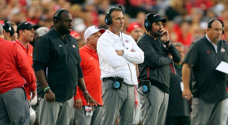 Ohio State Buckeyes head coach Urban Meyer (center) watches the game from the sidelines with assistant coach Ryan Day (right) and assistant coach Tony Alford (left) during the third quarter against the Ohio State Buckeyes at Ohio Stadium. Ohio State Buckeyes head coach Urban Meyer (center) watches the game from the sidelines with assistant coach Ryan Day (right) and assistant coach Tony Alford (left) during the third quarter against the Ohio State Buckeyes at Ohio Stadium.