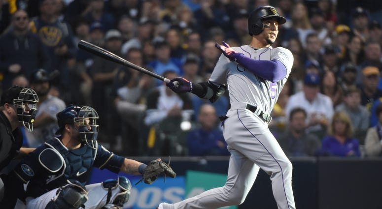 Oct 4, 2018; Milwaukee, WI, USA; Colorado Rockies outfielder Carlos Gonzalez hits a triple in the fifth inning against the Milwaukee Brewers in game one of the 2018 NLDS playoff baseball series at Miller Park. Mandatory Credit: Benny Sieu-USA TODAY Sports Oct 4, 2018; Milwaukee, WI, USA; Colorado Rockies outfielder Carlos Gonzalez hits a triple in the fifth inning against the Milwaukee Brewers in game one of the 2018 NLDS playoff baseball series at Miller Park. Mandatory Credit: Benny Sieu-USA TODAY Sports