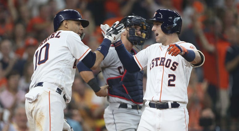 ouston Astros third baseman Alex Bregman (2) is congratulated by first baseman Yuli Gurriel (10) for hitting a solo home run as Cleveland Indians catcher Yan Gomes (center) looks on during the fourth inning in game one of the 2018 ALDS at Minute Maid Park Alex Bregman Yuli Gurriel Houston Astros