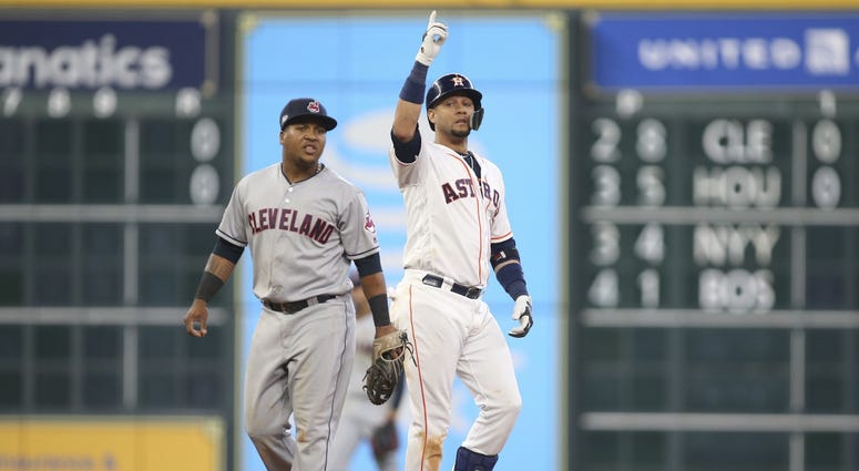 Houston Astros first baseman Yuli Gurriel (10) celebrates after hitting a double against Cleveland Indians second baseman Jose Ramirez (left) during the seventh inning in game one of the 2018 ALDS Yuli Gurriel Game 1 ALDS