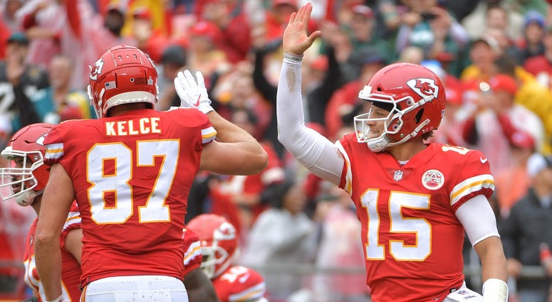 Kansas City Chiefs quarterback Patrick Mahomes (15) celebrates with tight end Travis Kelce (87) after scoring a touchdown during the first half against the Jacksonville Jaguars at Arrowhead Stadium. Pat Mahomes, Travis Kelce Kansas City Chiefs touchdown