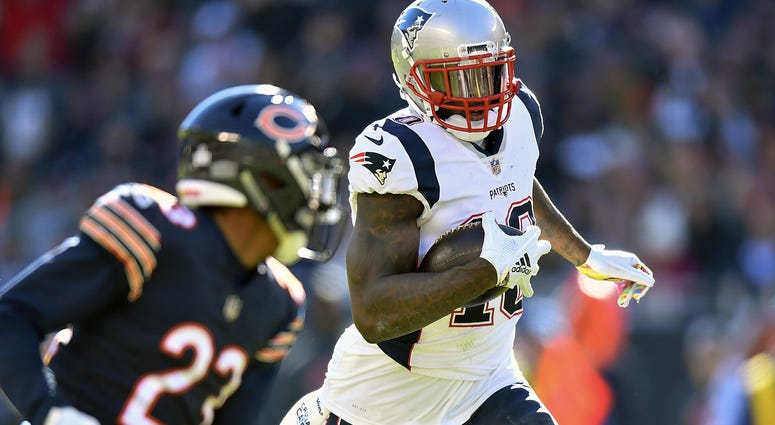 New England Patriots wide receiver Josh Gordon (10) runs with the ball against Chicago Bears cornerback Kyle Fuller (23) at Soldier Field.