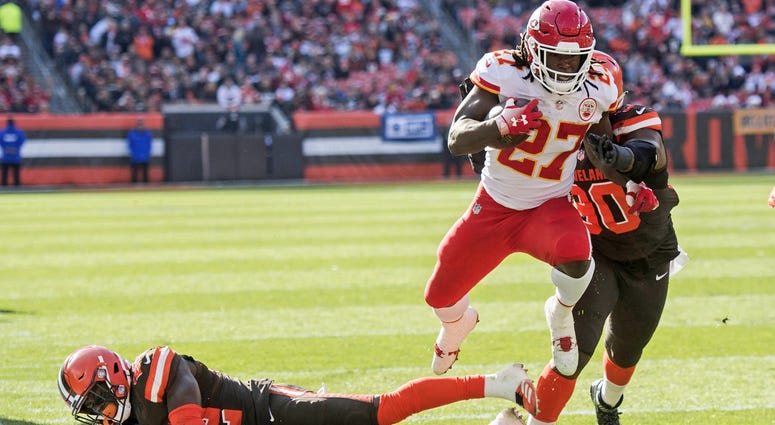 Kansas City Chiefs running back Kareem Hunt (27) eludes the tackle of Cleveland Browns free safety Jabrill Peppers (22) during the first half at FirstEnergy Stadium. Kareem Hunt scores touchdown against Cleveland Browns