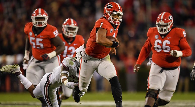 Georgia Bulldogs quarterback Justin Fields (1) runs with the ball against the Massachusetts Minutemen during the second half at Sanford Stadium. Georgia Bulldogs quarterback Justin Fields (1) runs with the ball against the Massachusetts Minutemen during the second half at Sanford Stadium.