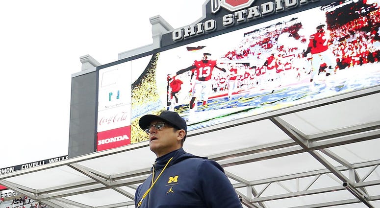 Michigan Wolverines head coach Jim Harbaugh walks on to the field before a game against the Ohio State Buckeyes at Ohio Stadium. Jim Harbaugh