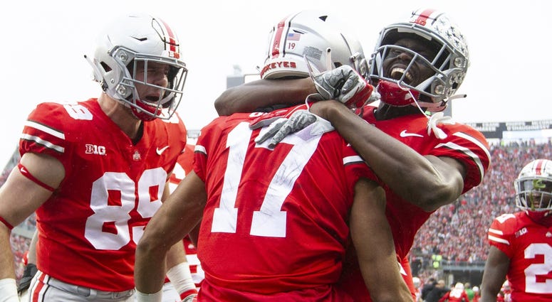 Ohio State Buckeyes wide receiver Chris Olave (17) is congratulated by tight end Luke Farrell (89) and wide receiver Binjimen Victor (9) after scoring a touchdown against the Michigan Wolverines at Ohio Stadium. Ohio State Buckeyes wide receiver Chris Olave (17) is congratulated by tight end Luke Farrell (89) and wide receiver Binjimen Victor (9) after scoring a touchdown against the Michigan Wolverines at Ohio Stadium.