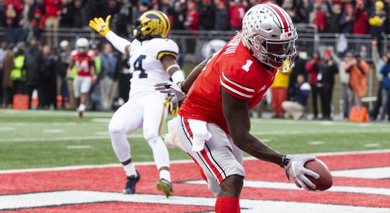 Ohio State Buckeyes wide receiver Johnnie Dixon (1) scores a touchdown as Michigan Wolverines defensive back Josh Metellus (14) gestures to the officials at Ohio Stadium. Johnnie Dixon Ohio State