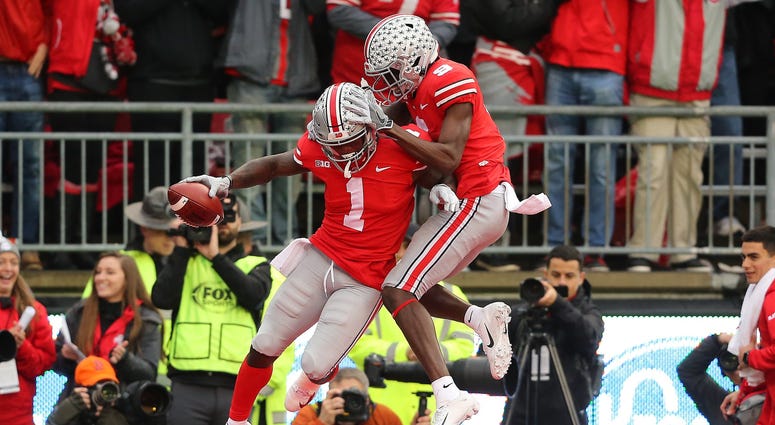 Ohio State Buckeyes wide receiver Johnnie Dixon (1) is congratulated by receiver Binjimen Victor (9) after scoring a second quarter touchdown against the Michigan Wolverines at Ohio Stadium. Johnnie Dixon Binjimen Victor Ohio State