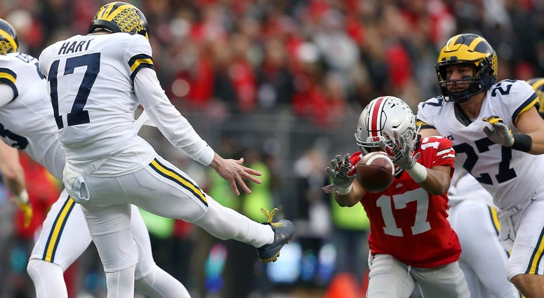 Ohio State Buckeyes wide receiver Chris Olave (17) blocks a punt attempt by Michigan Wolverines punter Will Hart (17) during the third quarter at Ohio Stadium. Chris Olave Ohio State