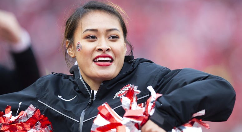 An Ohio State Buckeyes cheerleader entertains fans during a game against the Michigan Wolverines at Ohio Stadium.