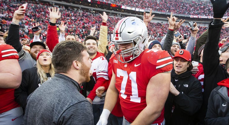 Ohio State Buckeyes offensive lineman Josh Myers (71) celebrates with fans after defeating the Michigan Wolverines at Ohio Stadium.
