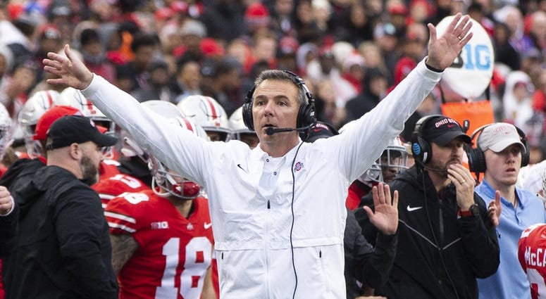 Ohio State Buckeyes head coach Urban Meyer tries to get the attention of the referee against the Michigan Wolverines at Ohio Stadium. Urban Meyer
