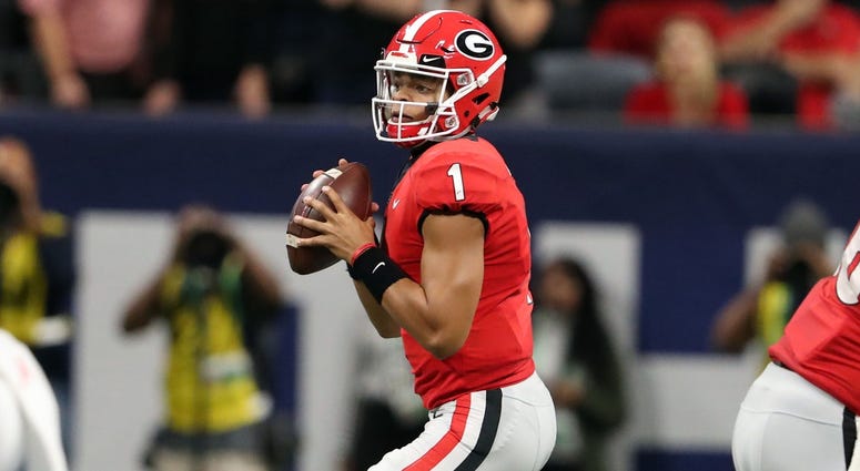 Georgia Bulldogs quarterback Justin Fields (1) looks to throw against the Alabama Crimson Tide during the second quarter in the SEC championship game at Mercedes-Benz Stadium. Georgia Bulldogs quarterback Justin Fields (1) looks to throw against the Alabama Crimson Tide during the second quarter in the SEC championship game at Mercedes-Benz Stadium.