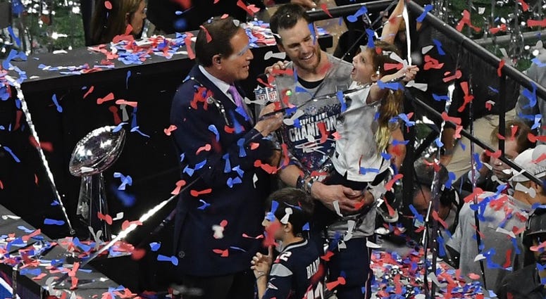 New England Patriots quarterback Tom Brady (12) celebrates with his daughter Vivian after winning Super Bowl LIII at Mercedes-Benz Stadium.