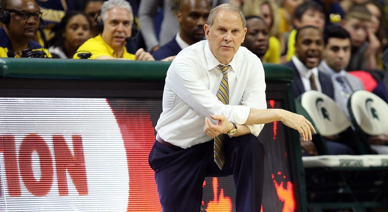 Michigan Wolverines head coach John Beilein knees on the court during the second half of a game against the Michigan State Spartans at the Breslin Center. Michigan Wolverines head coach John Beilein knees on the court during the second half of a game against the Michigan State Spartans at the Breslin Center.