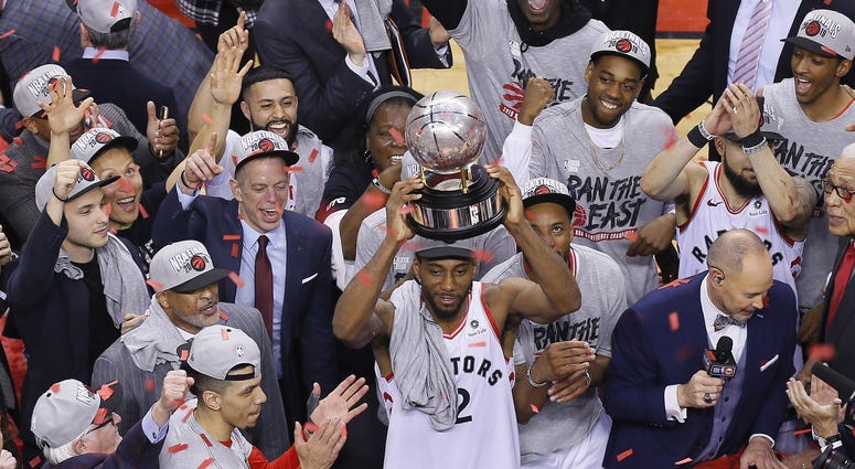 NBA: Playoffs-Milwaukee Bucks at Toronto Raptors Toronto, Ontario, CAN; Toronto Raptors forward Kawhi Leonard (2) hoist the Eastern Conference trophy after winning game six of the Eastern conference finals