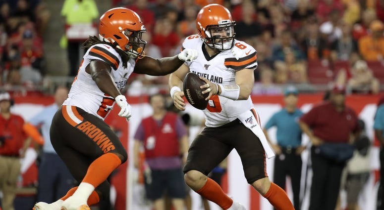 Cleveland Browns quarterback Baker Mayfield (6) fakes a handoff to running back Kareem Hunt (27) during the game against the Tampa Bay Buccaneers at Raymond James Stadium. Cleveland Browns quarterback Baker Mayfield (6) fakes a handoff to running back Kareem Hunt (27) during the game against the Tampa Bay Buccaneers at Raymond James Stadium.