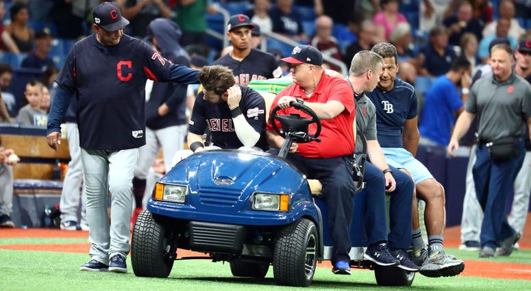 Aug 30, 2019; St. Petersburg, FL, USA; Cleveland Indians right fielder Tyler Naquin (30) is greeted by manager Terry Francona (77) while being carted off the field after an apparent injury at the end of the fifth inning against the Tampa Bay Rays at Tropi Cleveland Indians right fielder Tyler Naquin (30) is greeted by manager Terry Francona (77) while being carted off the field after an apparent injury at the end of the fifth inning against the Tampa Bay Rays at Tropicana Field.